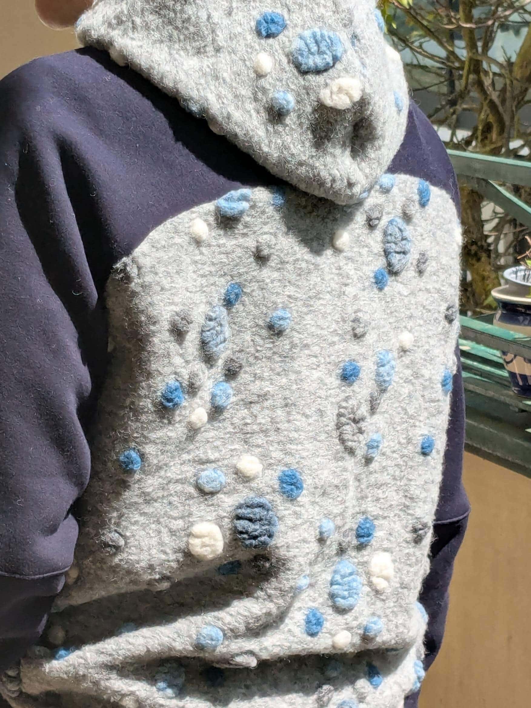 Hoodie aus blau grau gepunktetem Musterwalk getragen von hinten