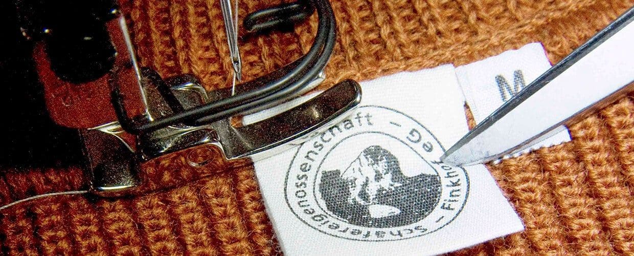 Nahaufnahme von Kleidungsstück dem Finkhof Etikett eingenäht wird