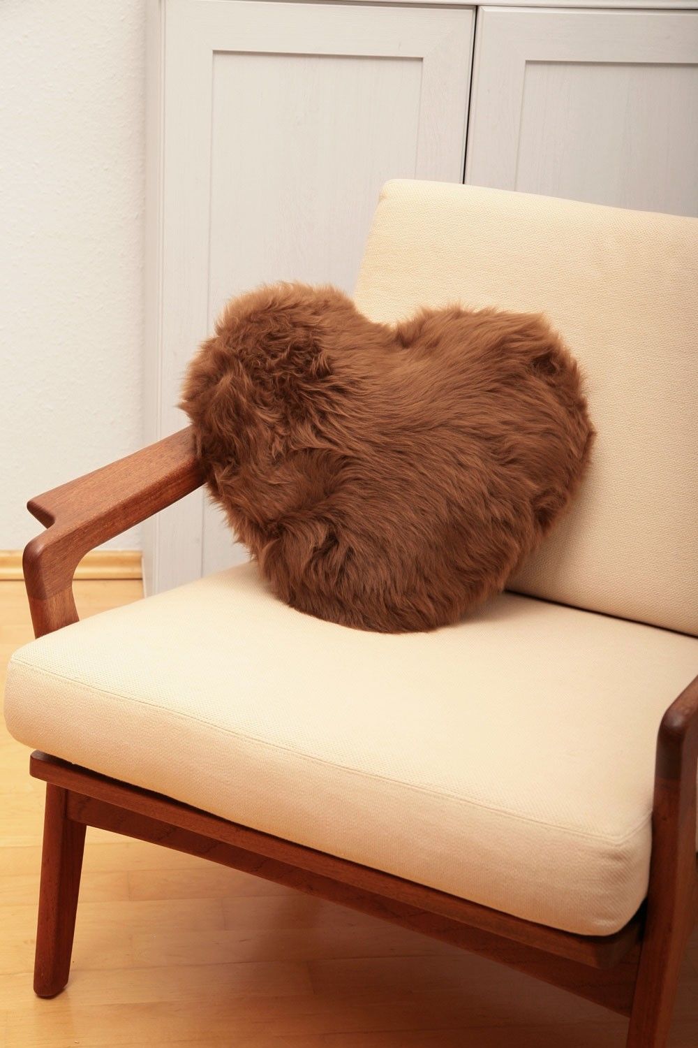 braunes Finkhof Herzkissen aus pflanzlich gegerbtem Schaffell auf Sessel