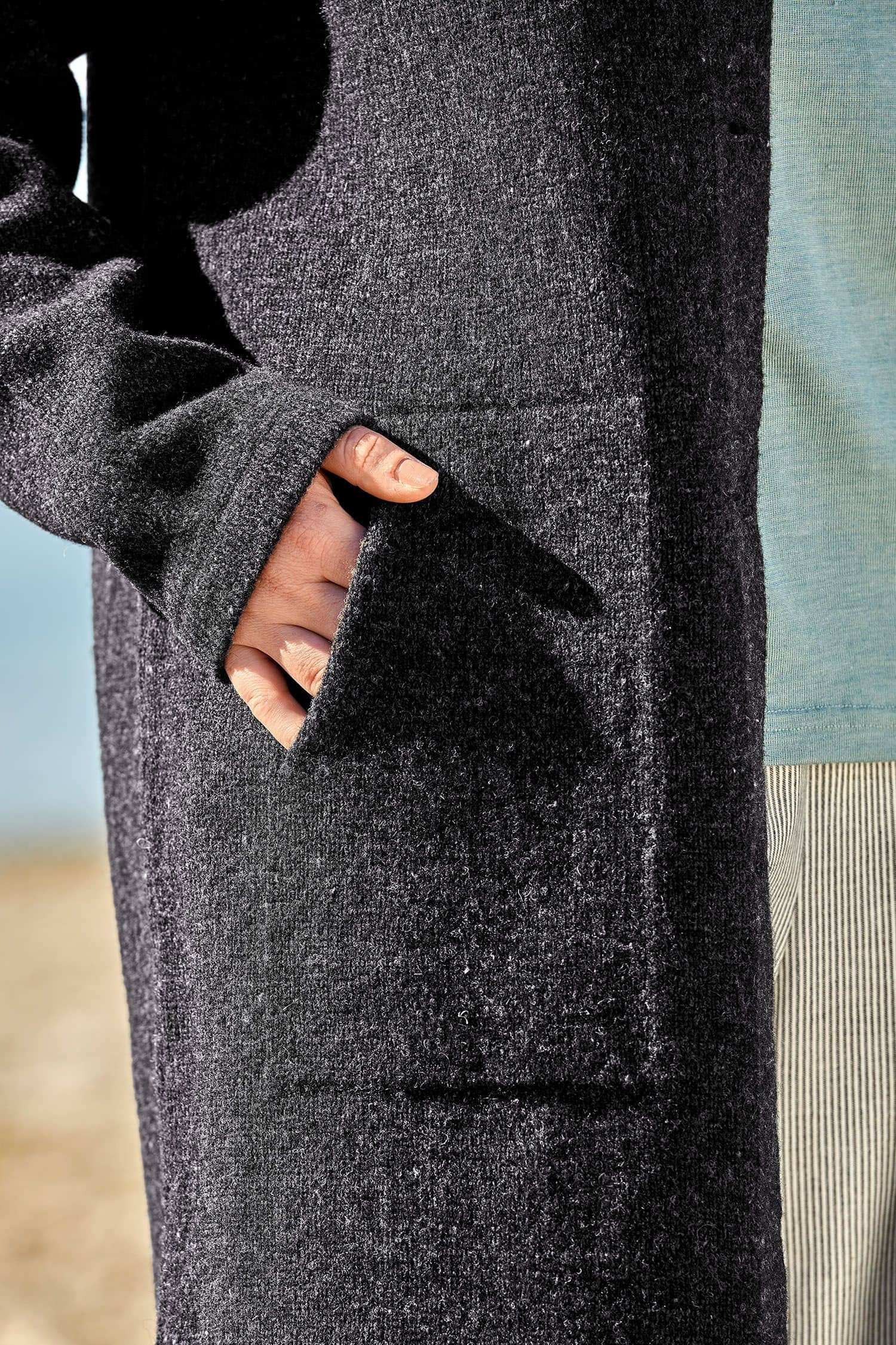 Detailaufnahme der Taschen des dunkelgrauen Finkhof Strickmantel aus bio Wolle (kbT)