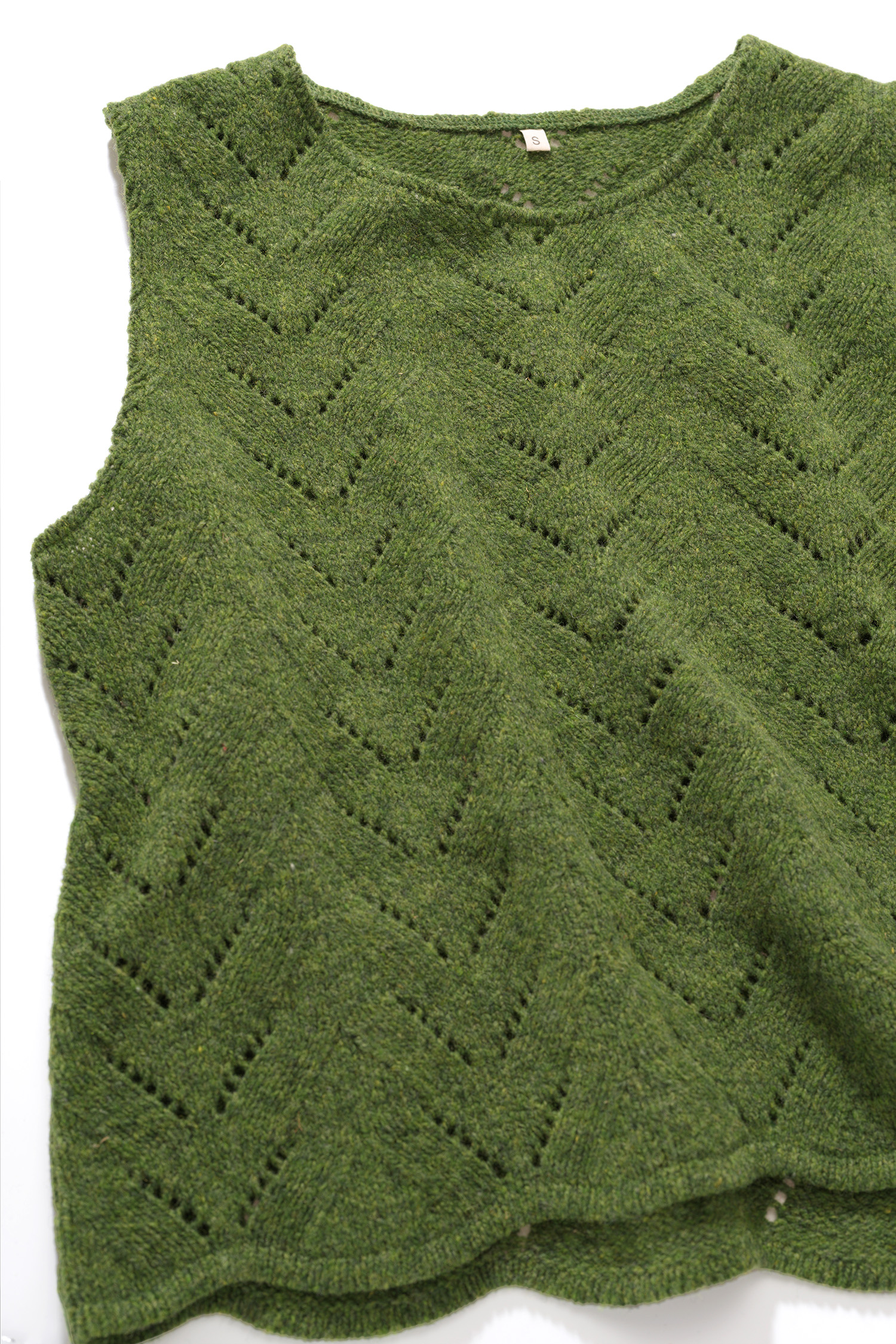 Nahaufnahme der Struktur des grünen Strickpullunder aus Bio-Wolle vom Finkhof