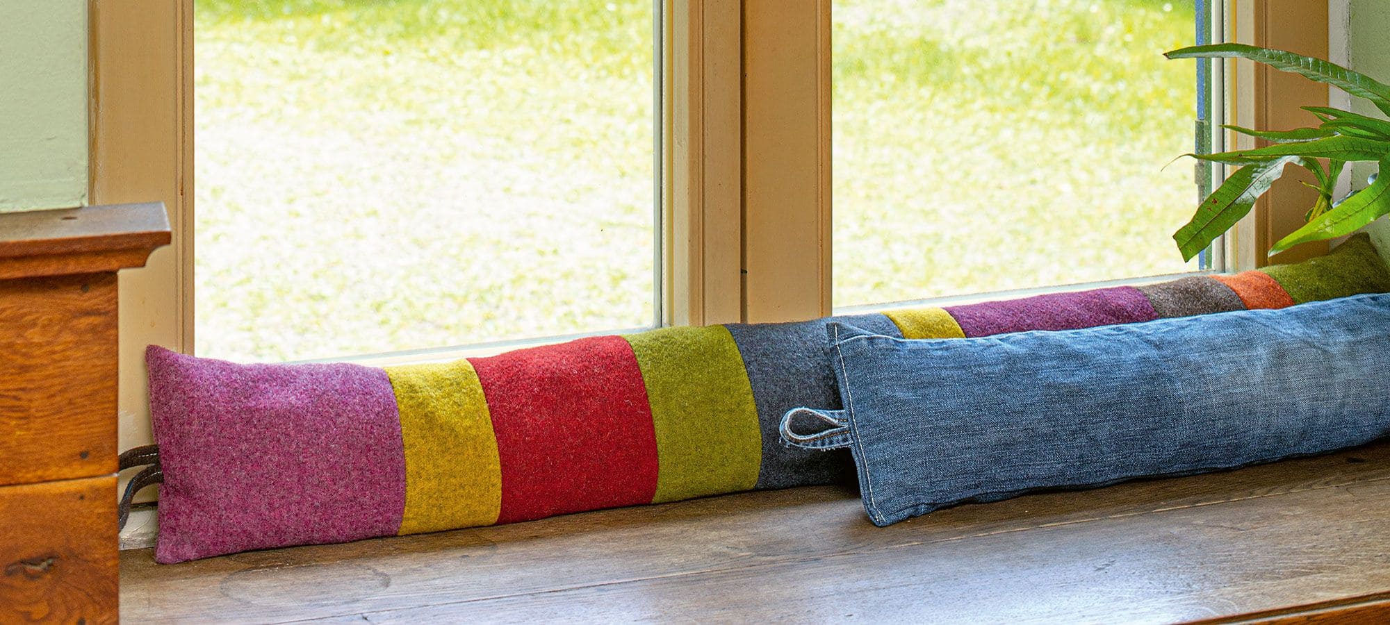 Nähanleitung Zugluftschlange Fenster mit gestreifter und jeansfarbener Zugluftschlage als Beispiel aus dem Buch ,,Flicken und stopfen"