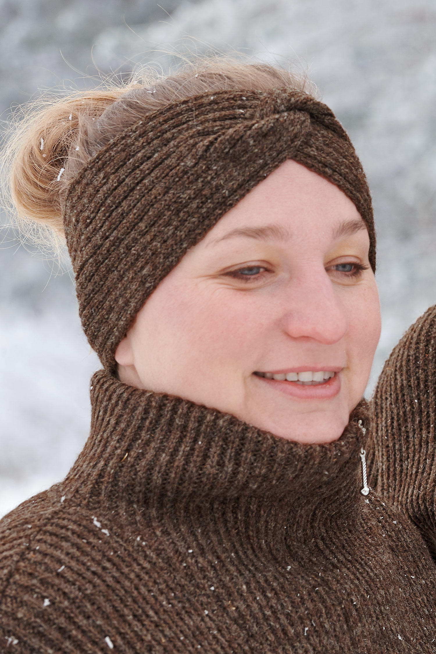 Detailansicht vom Kragen des braunen Finkhof Troyer aus bio Wolle (kbT) und Frau mit Stirnband