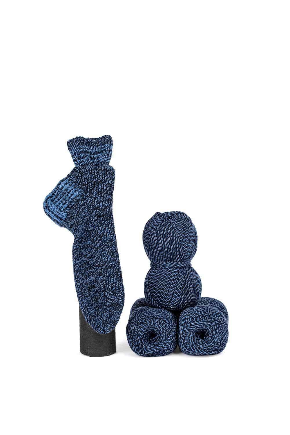feine Finkhof Sockenwolle mit Melangeeffekt aus bio Wolle (kbT) in blau/ schwarz mit Wollknäulen und Stricksocken