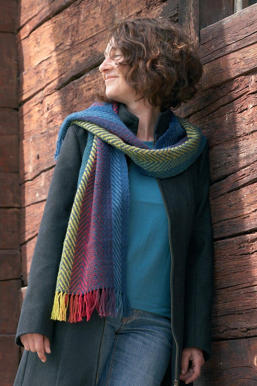 Pflanzengefärbter Wollschal -handgewebt- regenbogen Fraul trägt pflanzengefärbten und handgewebten Wollschal aus bio Wolle (kbT) vom Finkhof in Regenbogenfarben