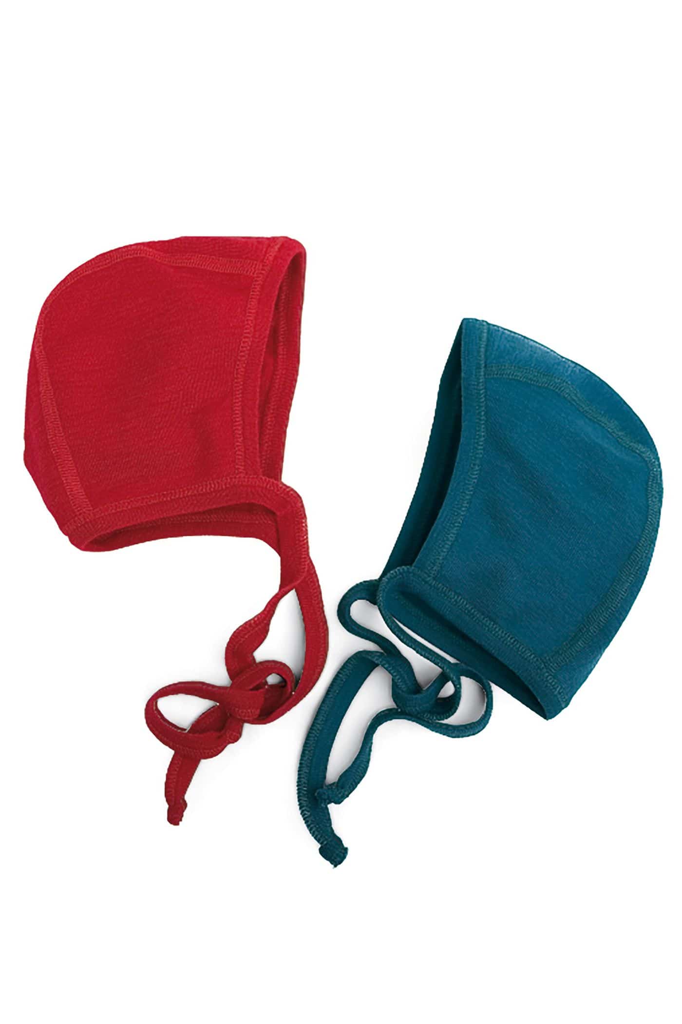Babyhäubchen zwei Babymützen aus bio Wolle (kbT) liegen in rot und blau auf Tisch