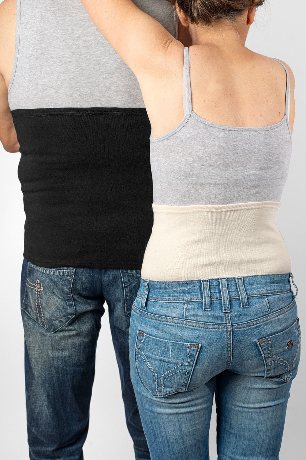 Nierenwärmer leicht Mann und Frau von hinten mit Jeans, grauem Top und leichtem Nierenwärmer in schwarz und naturweiß
