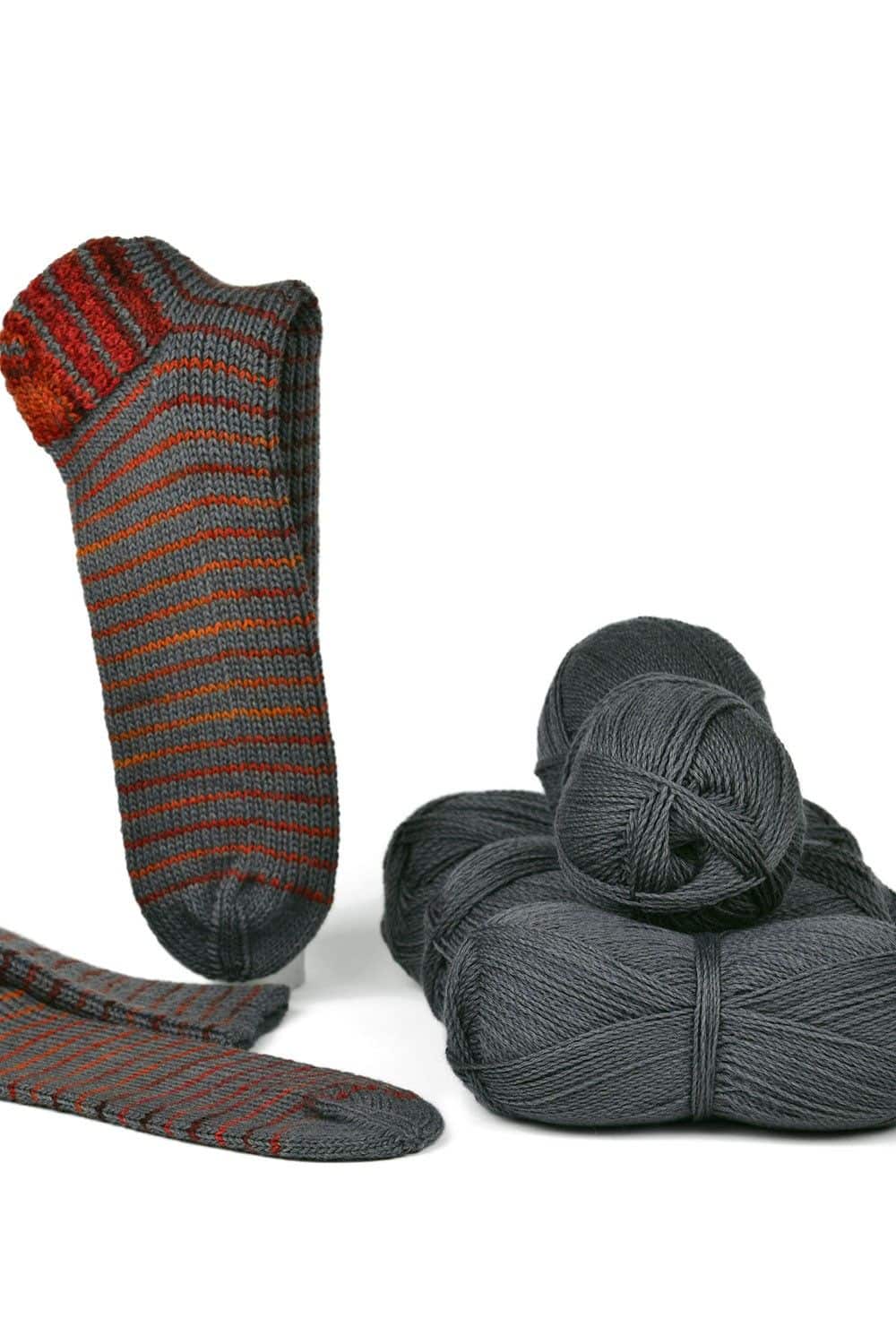 feine graue Finkhof Sockenwolle aus bio Wolle (kbT) als Knäule und fertiger grau orange gestreifter Stricksocke