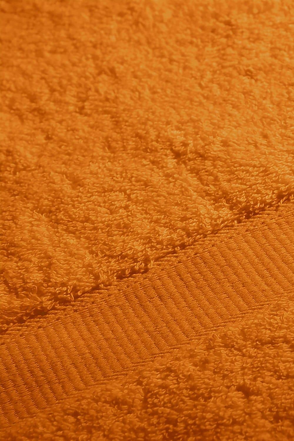 Detailaufnahme von orangem Duschtuch aus bio Baumwolle (kbA) mit 70x140cm