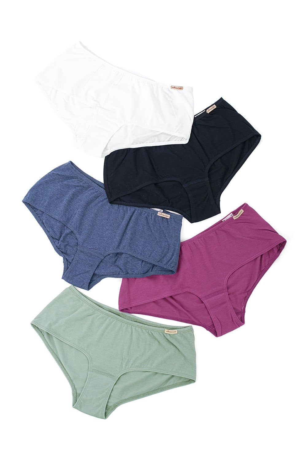 Baumwoll-Damen-Panty Damen Pantys aus bio Baumwolle (kbA) und Elasthan in fünf Farben auf weißem Untergrund ausgelegt