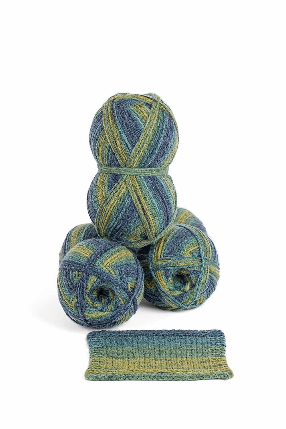 Knäule mit blau grünem Farbverlauf und Strickstück aus dünner bio Merinowolle (kbT) vom Finkhof, weißer Untergrund
