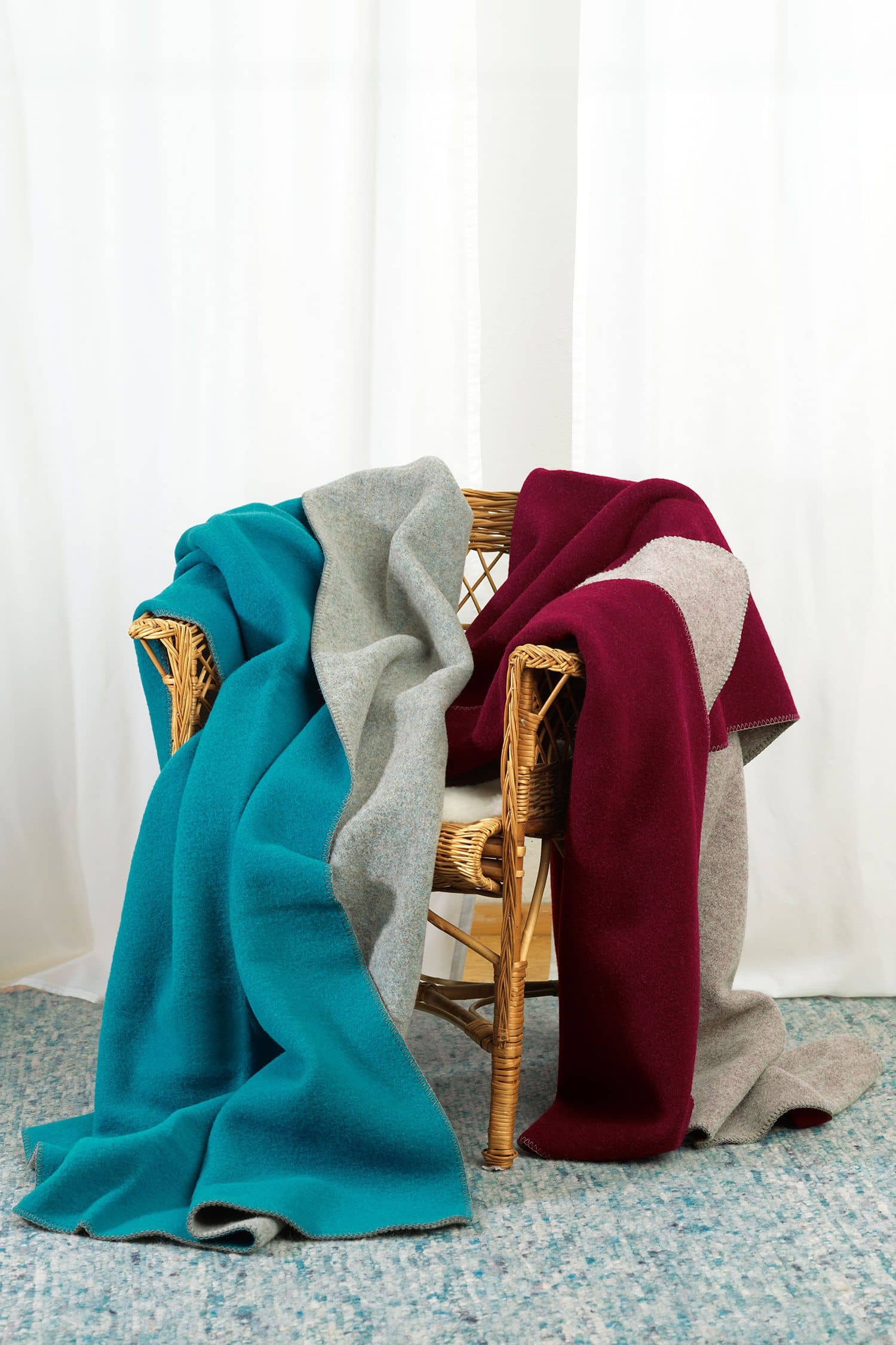 Finkhof-Wolldecke Doubleface gemütlicher Stuhl über dem Finkhof doubleface Wolldecke aus bio Wolle (kbT) in burgund/ grau und türkis/grau hängen