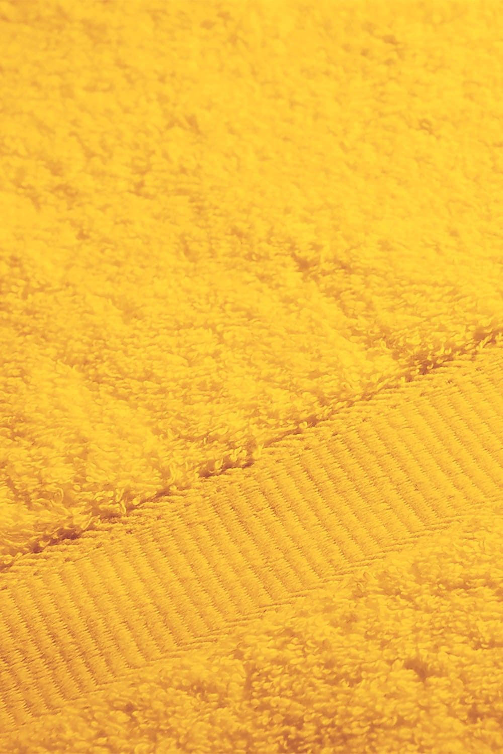 Detailaufnahme von gelbem Duschtuch aus bio Baumwolle (kbA) mit 70x140cm