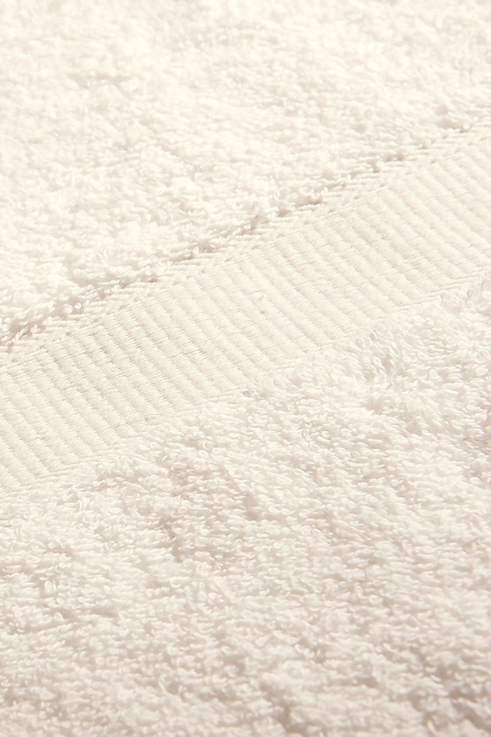 Detailaufnahme von naturweißem Duschtuch aus bio Baumwolle (kbA) mit 70x140cm