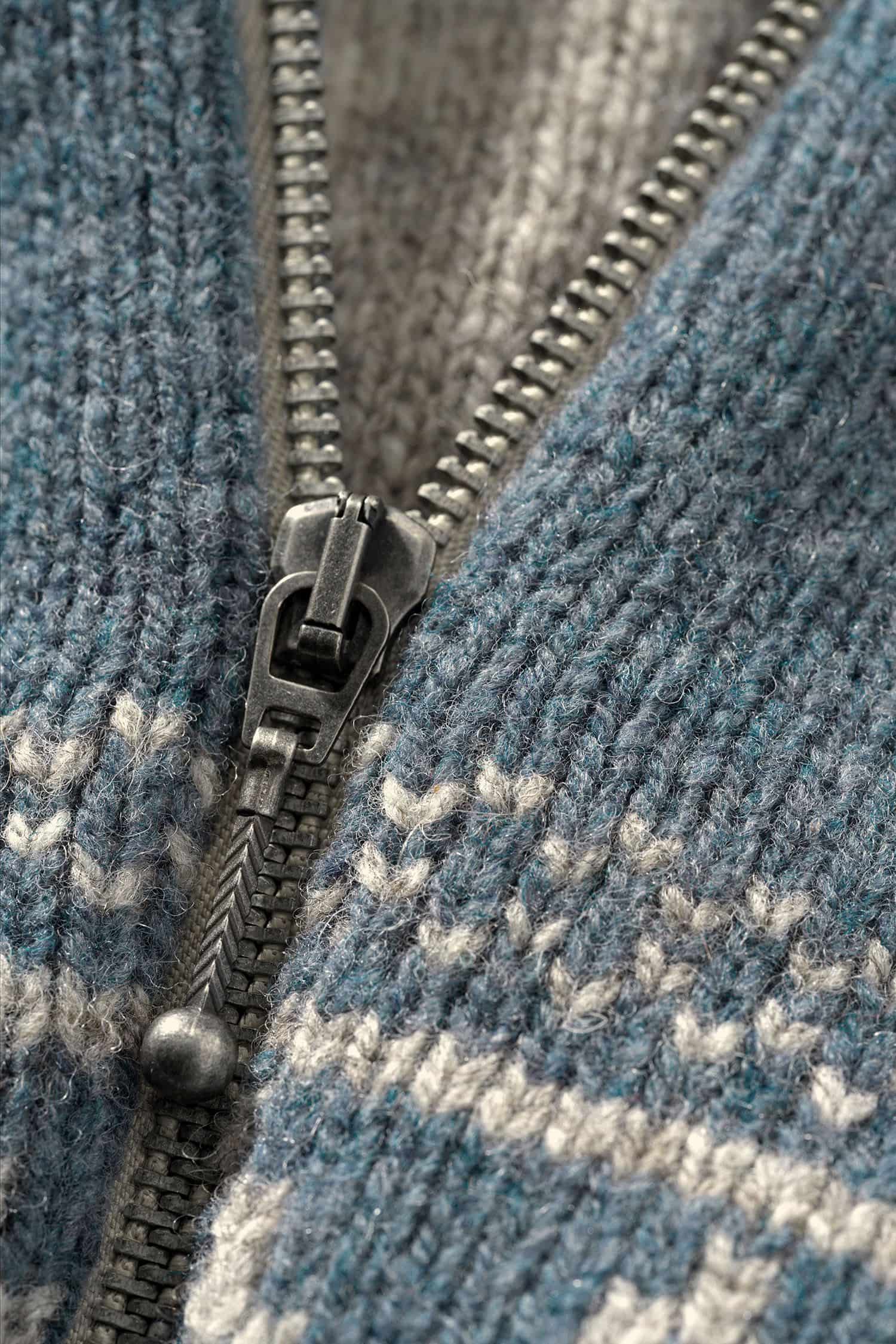 Nahaufnahme des Reißverschlusses der rauchblauen Norweger Kapuzenjacke aus bio Wolle (kbT) vom Finkhof
