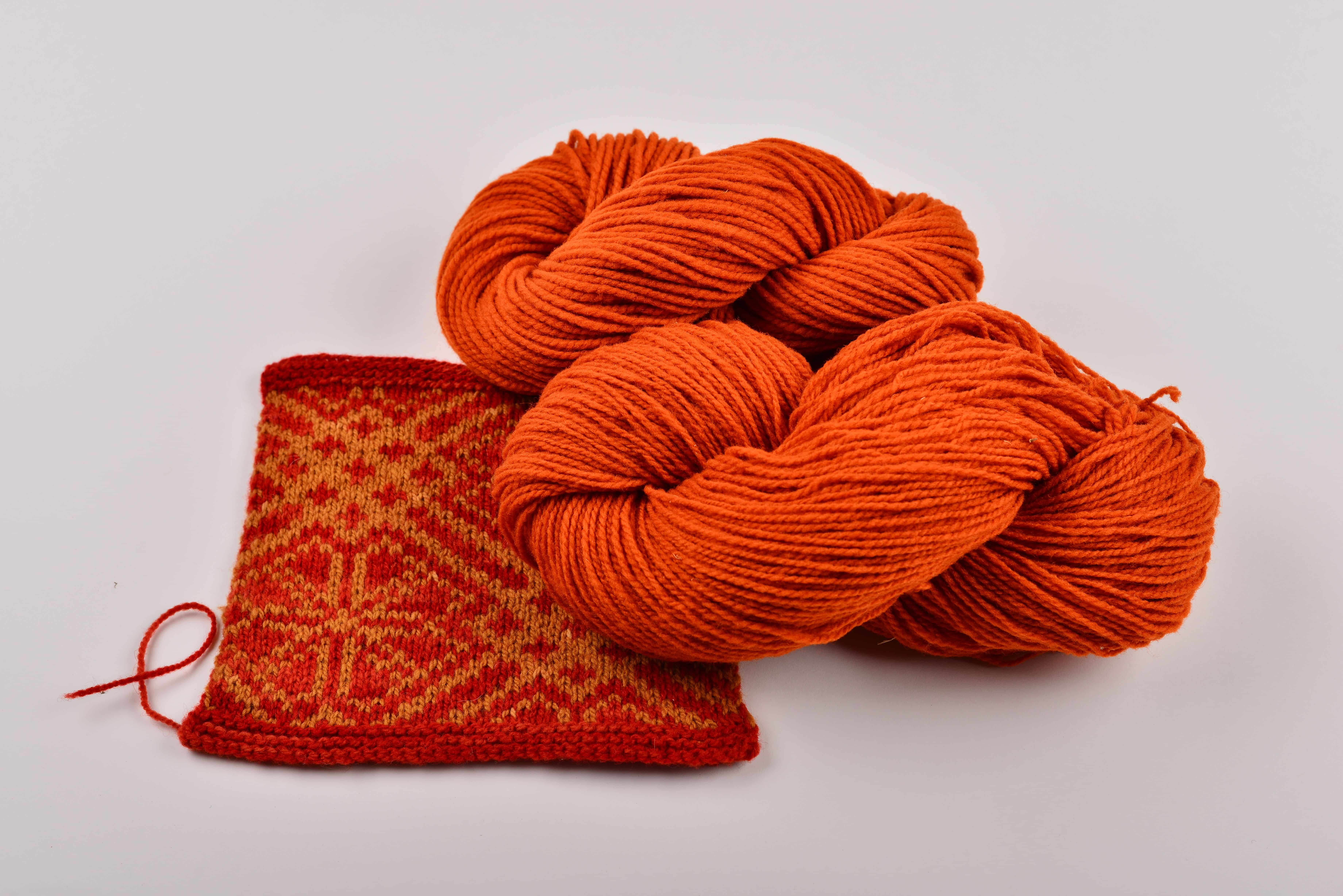 dünne orangemelierte bio Merinowolle (kbT) vom Finkhof mit kleinem Strickstück davor