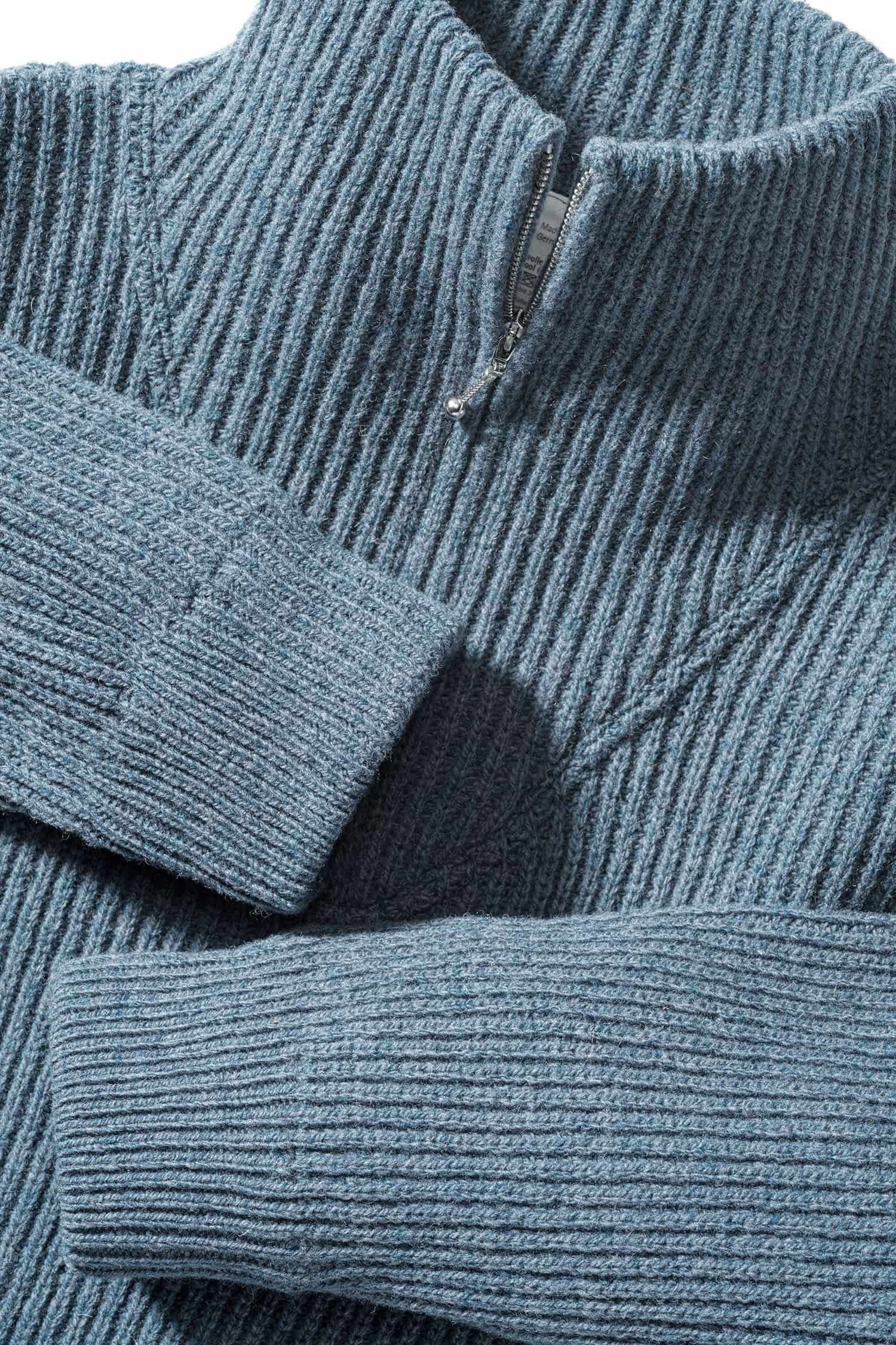 Detailaufnahme der Ärmel und des Kragen des rauchblauen Finkhof Troyers aus bio Wolle (kbT)