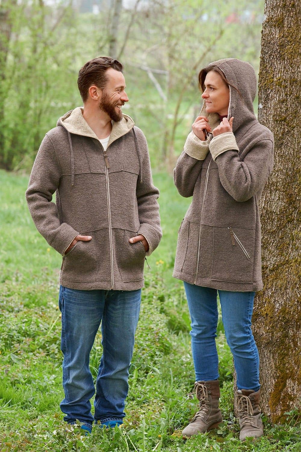 Mann und Frau tragen walnussbraune Jacke mit Kapuze aus bio Wolle (kbT) vom Finkhof