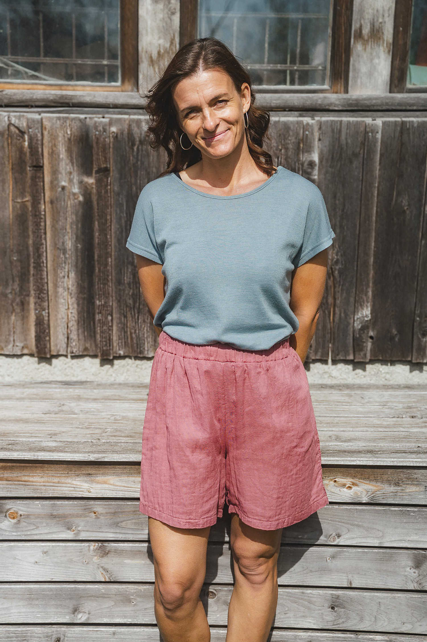 Damenshorts aus Bio-Baumwoll-Musselin Frau trägt blaues Shirt und altrosafarbene Shorts aus Bio-Baumwoll-Musselin (kbA) vom Finkhof